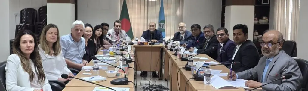 Participants seated around a conference table at a Bangladesh Insurance Association meeting