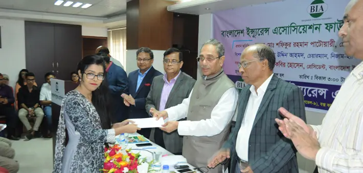 Certificate being handed to a recipient at a Bangladesh Insurance Association Foundation programme